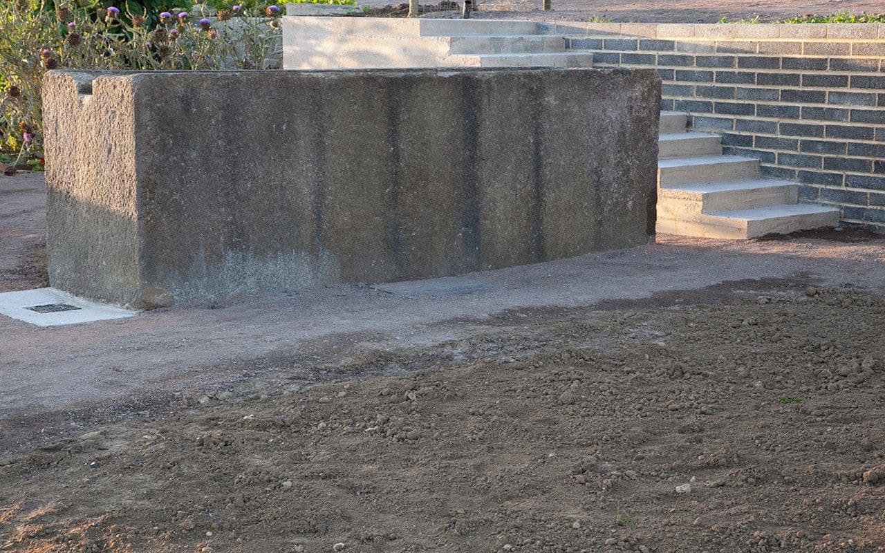 Granite trough and shuttered concrete steps in Dan Pearson's Somerset garden